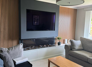 Living room with grey sofa and TV unit