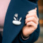 sterling silver brooch worn on a navy blue jacket, handmade jewellery by bottlebee in Nottingham