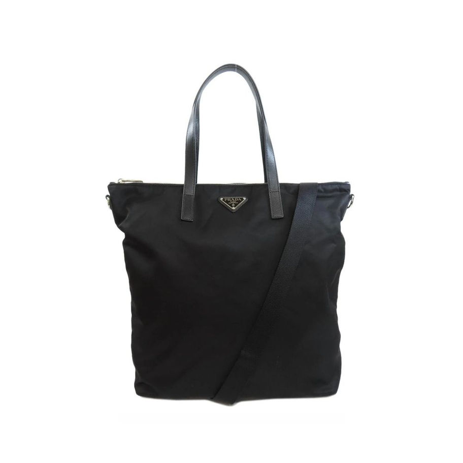 Black nylon tote bag with leather handles and crossbody strap