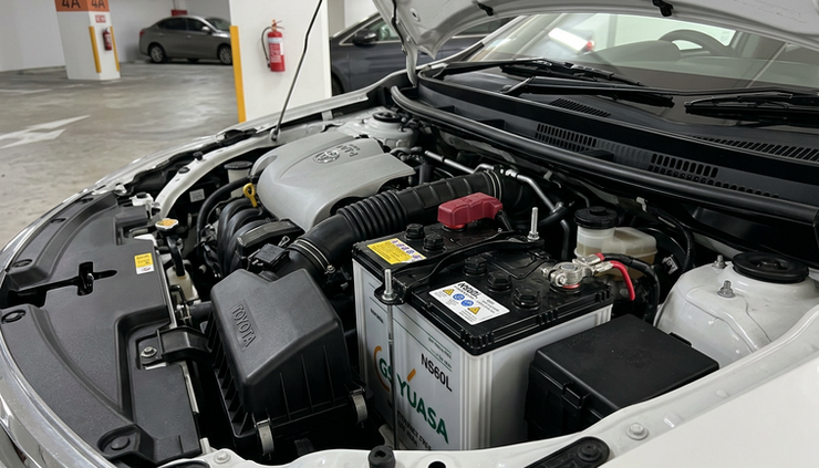 Close-up view of a car battery under an open bonnet