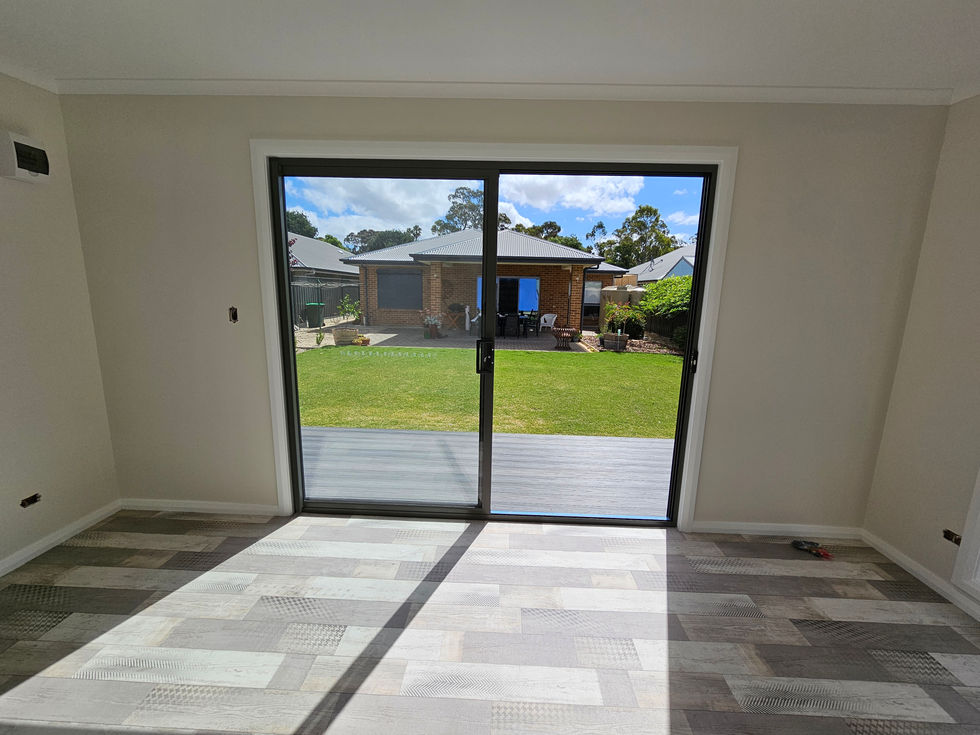 Glass sliding doors opening to a backyard view.
