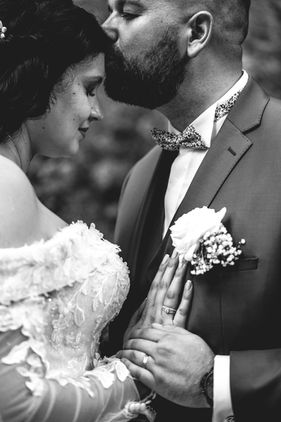 Couple de mariés en noir et blanc dans un moment intime