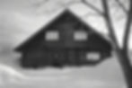 Exterior of NABARAKU mountain lodge in Hakuba, Japan, wooden facade surrounded by snow