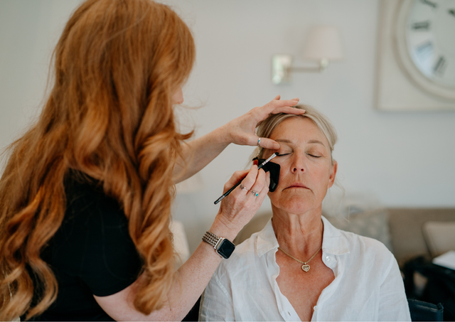 Mother of the bride getting her makeup done by Toni Todd Bridal on Rosalie's wedding morning at Farbridge Barns, Chichester