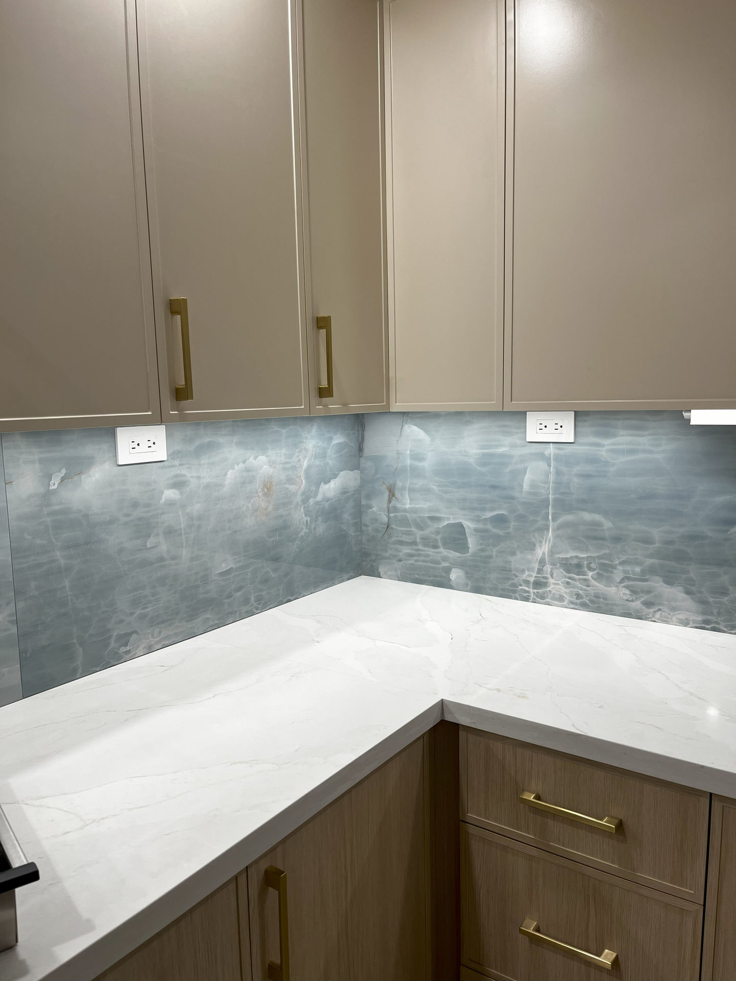 Blue kitchen backsplash and white countertops in King City