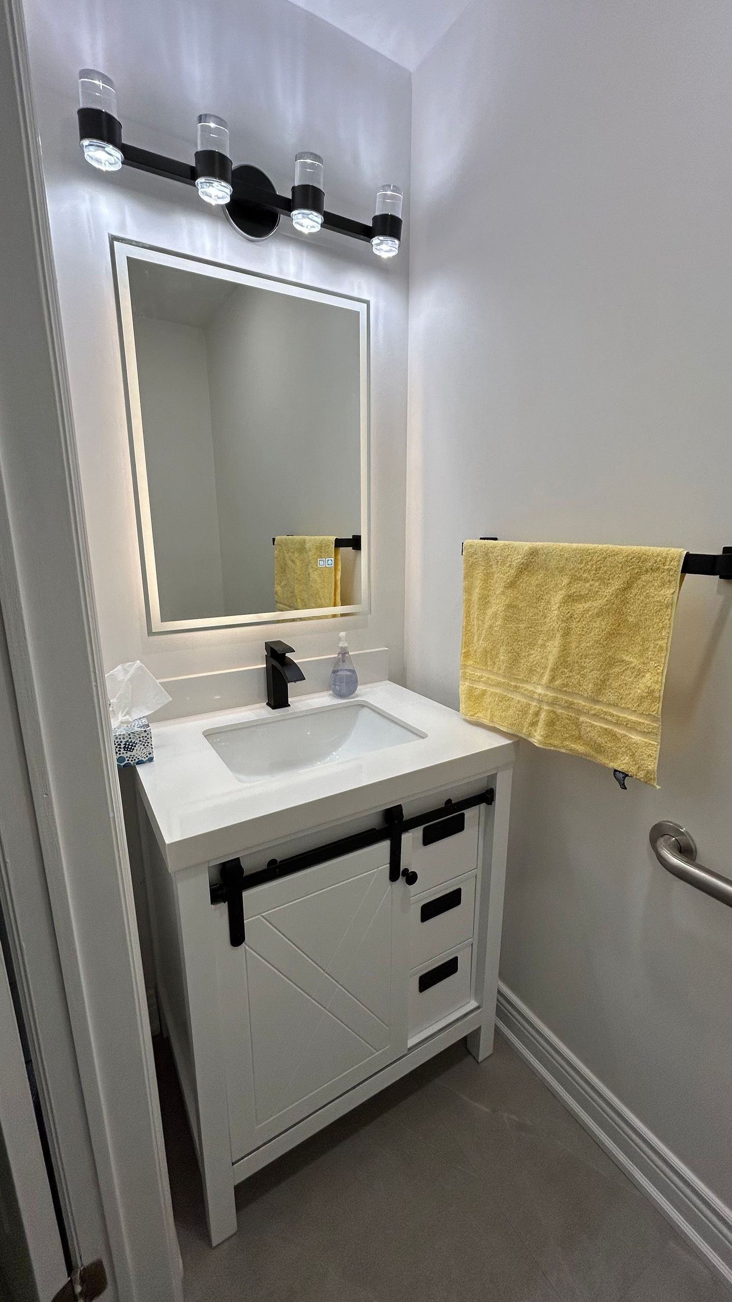 Washroom vanity and mirror with lights in Richmond Hill