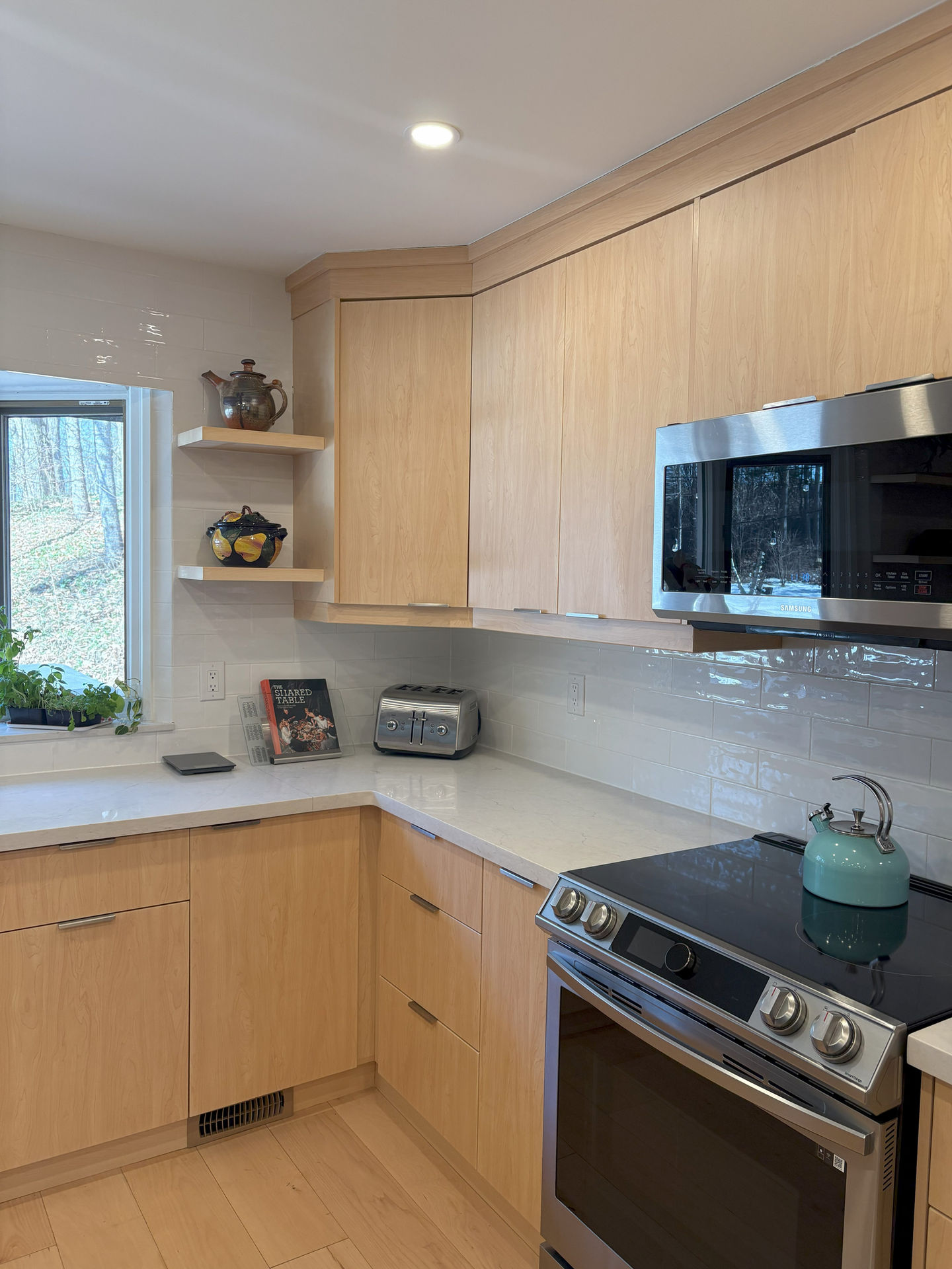 Kitchen countertop and stove with blue kettle