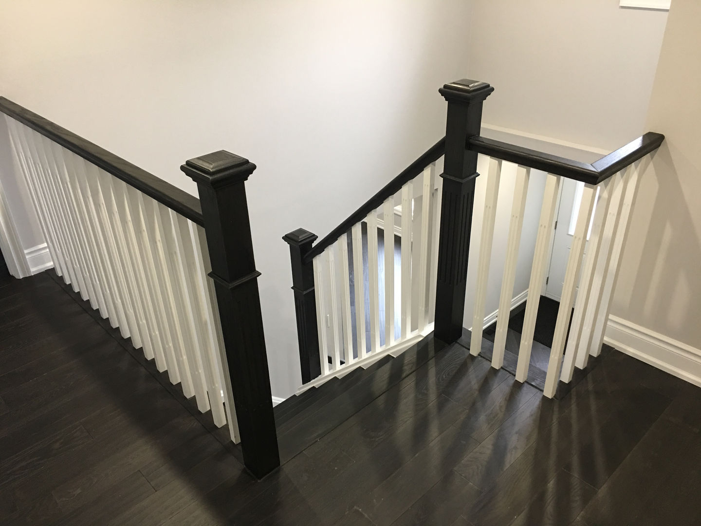 staircase looking downward with black hardwood floors in Newmarket