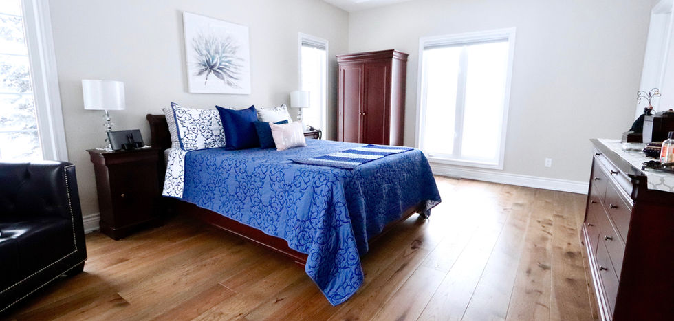 Brown engineered hardwood in bedroom by Pearl Knstructions