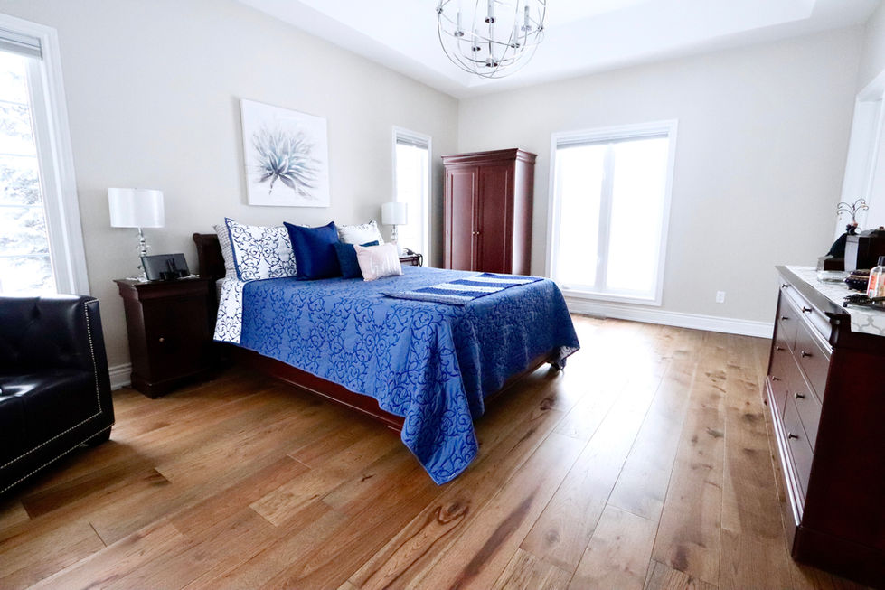 Brown engineered hardwood flooring with bed built by Pearl Knstructions