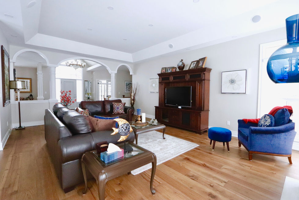 Black sofa and furniture on top of natural hardwood flooring