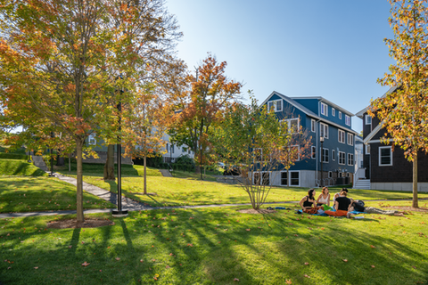 image of students on the grass at tufts university housing