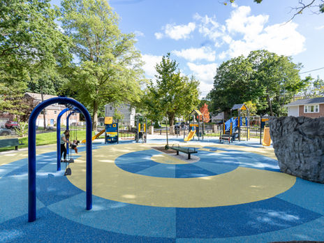 playground with arcs of bright blue and yellow play surfacing.