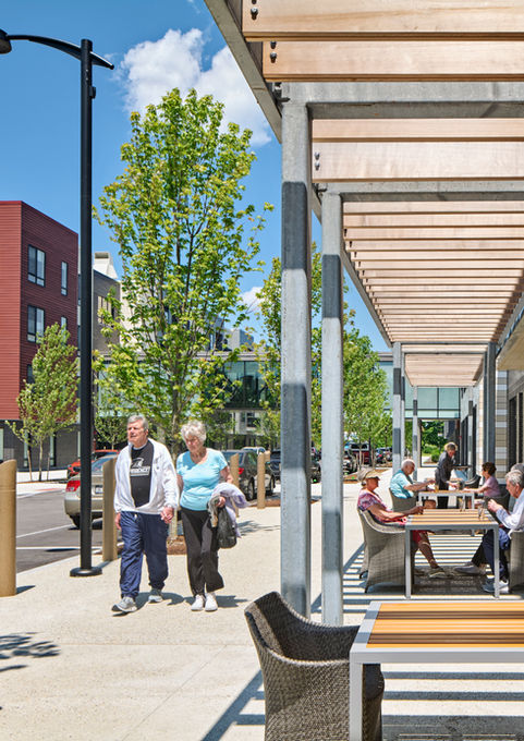 Outdoor seating under canopy at Woodmont Independent Living campus - Crowley Cottrell LLC Landscape Architecture
