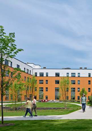 Outdoor courtyard with lawn and seating at UMass Amherst Fieldstone Apartments