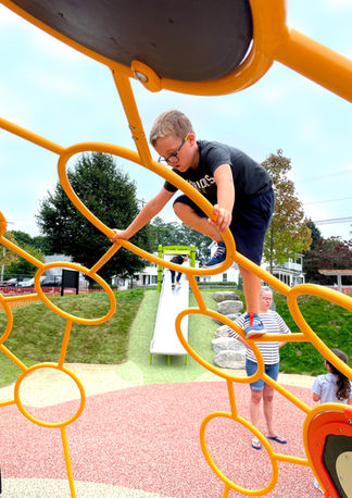 Child on yellow play structure at Hovey Park