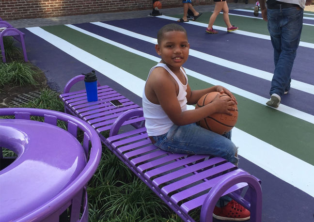 Child sitting on a purple bench at Ward Street Park