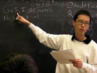 Dr. Reginald Thio teaches in front of a chalkboard during a university lecture at MIT in the U.S., pointing to oxidation states while holding notes; a moment of academic clarity and mentorship in action.