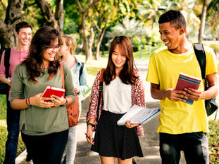Group of diverse students walking outdoors with books and smiles — symbolising confidence, friendship, and the forward momentum of strategic education. Reflects Ryse Education’s belief that every child deserves personalised academic mentorship to thrive in Singapore’s evolving landscape.