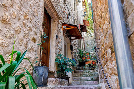 HealthyStudio512 Ancient stone townhouse with small windows and steep exterior staircase