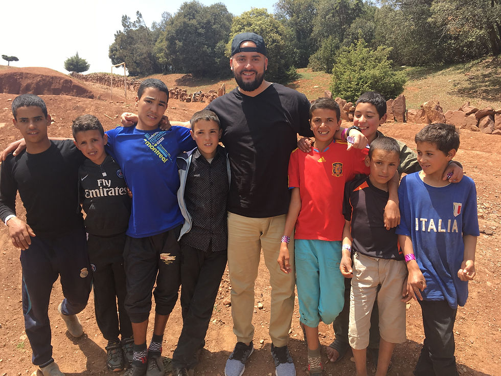 Posing with the neighborhood cool kids after watching them play soccer