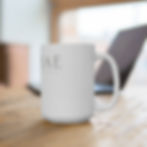 a white mug with the A Curiae logo