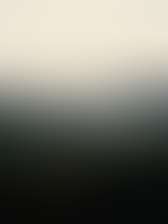 an above tree line POV of the mountains at dusk. smoky haze rolls in between the dips