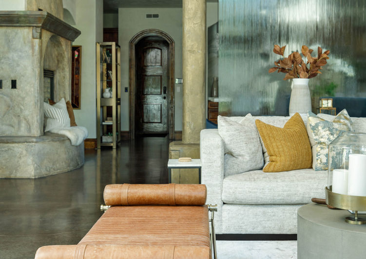 Living room bench and sofa with waterfall, kitchen, and dining room in the background