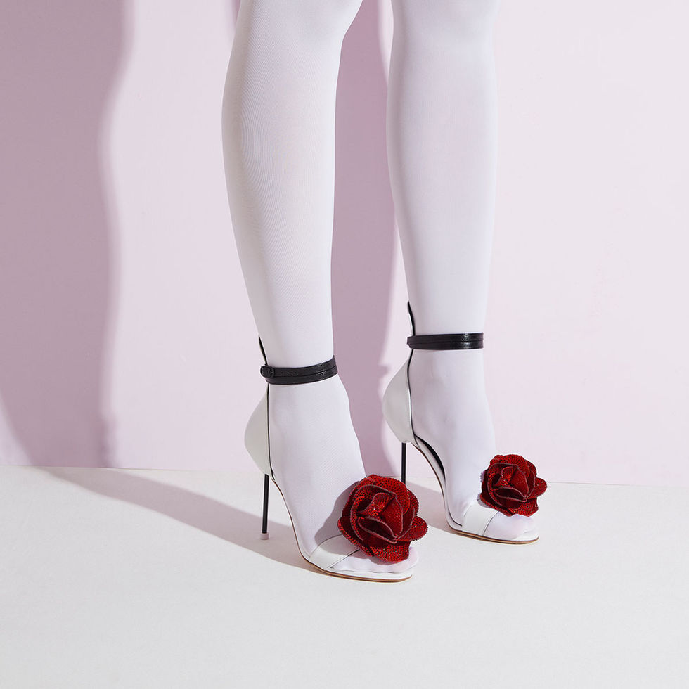 red flowers on a white sandal with black high heels