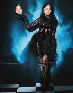 Bella Poarch wearing Giseli Dias Maria Black feather sandals in tmrw magazine