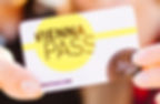 Hands holding a "Vienna Pass" card with yellow circle, black and white text. Text reads "Adult 3 Days." Bright, blurred background.