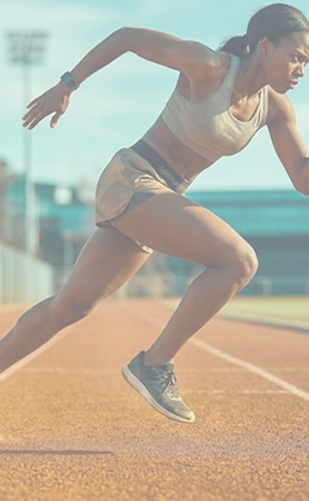 Female athlete sprinting at speed on a track in athletic wear, part of the hero collage for Functional Body Clinic sports massage