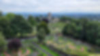 A panoramic view from Stirling Castle, showing an historic cemetery in the foreground and the Church of the Holy Rude in the background, all under a cloud-filled sky.