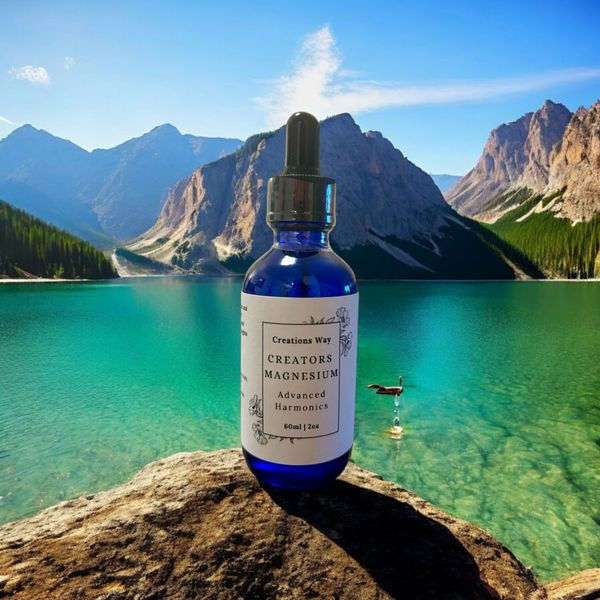Blue dropper bottle on rock overlooking turquoise lake and mountains