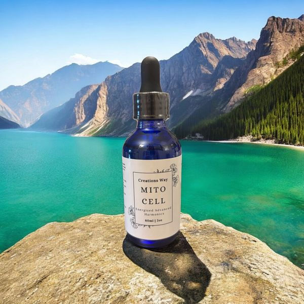 Blue dropper bottle, MITO CELL, on rock by mountain lake