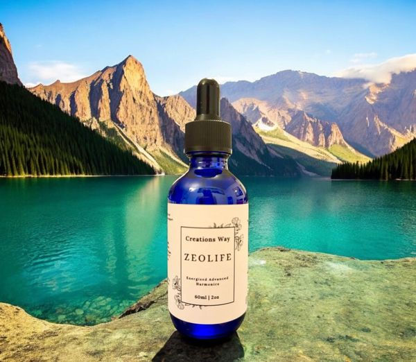 Olive Leaf bottle with a dropper by a turquoise mountain lake