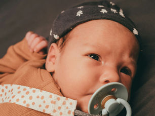  a baby using a pacifier