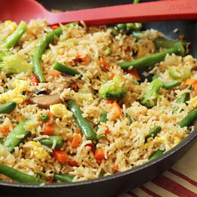 Delicious fried rice with vegetables in a pan, ready to serve.