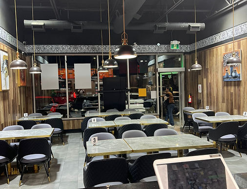 Restaurant interior with tables, chairs, and lights; empty, waiting for customers My Site 3