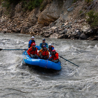 Group enjoying an exciting whitewater rafting adventure on a guided Denali river trip in Alaska.