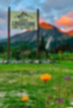 Sign with mountains in background with the midnight sun