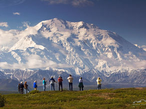 Hikers with Denali towering in the background
