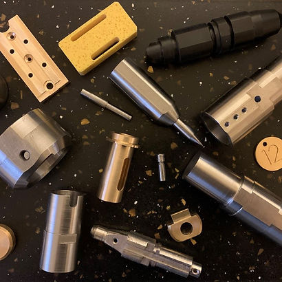 metal and plastic machined products on black background