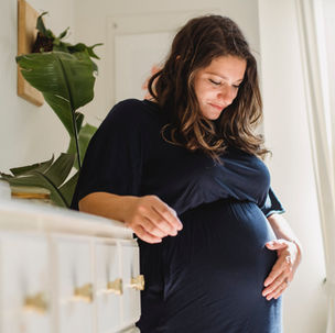 Woman holding her belly prior to birth