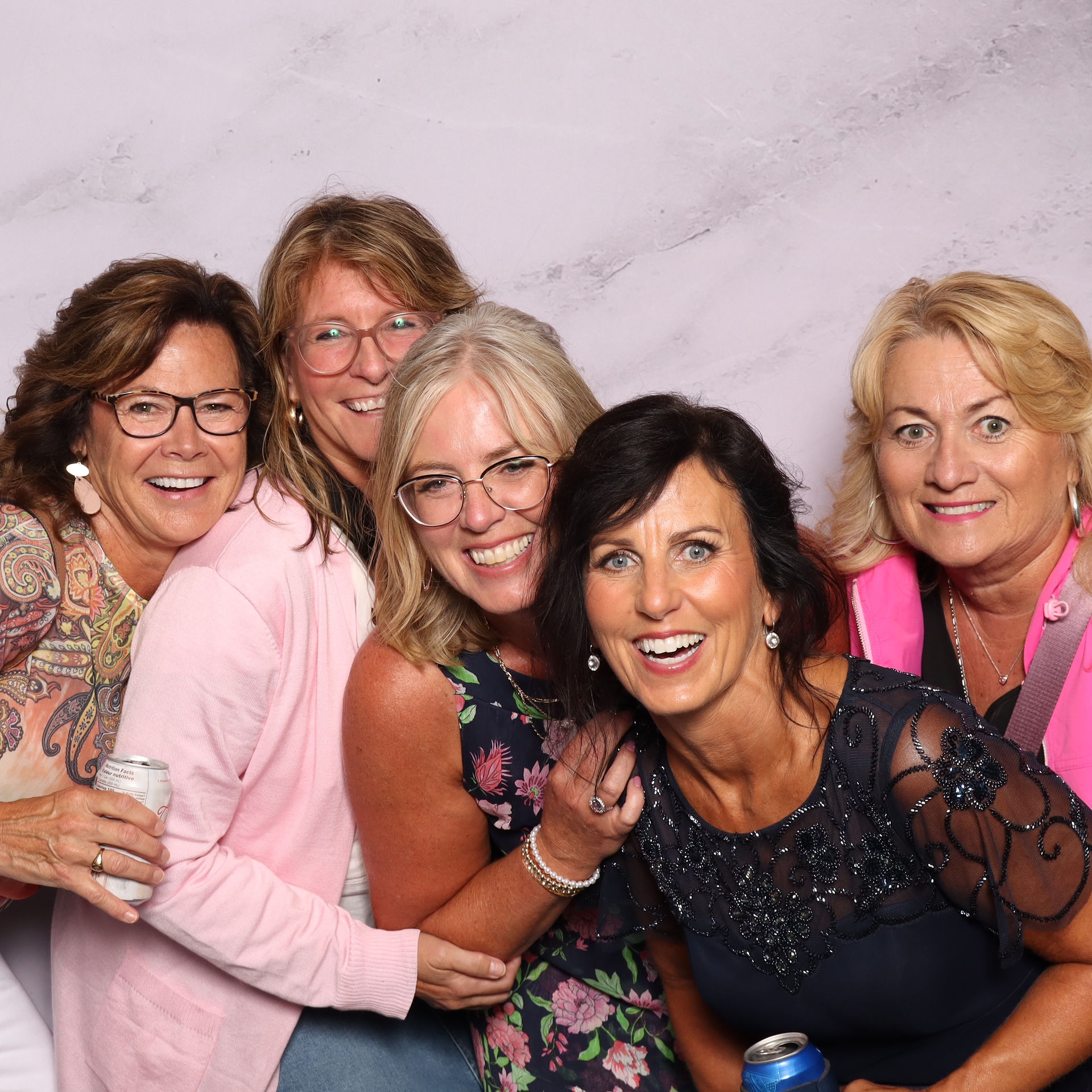 Four wedding guest women pose for the photo booth