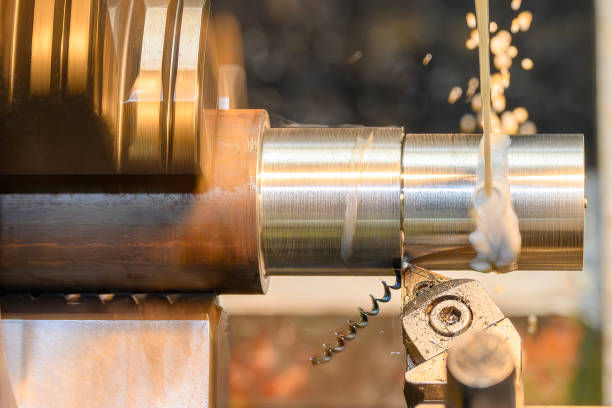 A metal lathe machining a cylindrical piece with coolant spraying, showcasing high-performance carbide tooling in action.