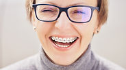Patient smiles after getting new braces from orthodontist David Bright.