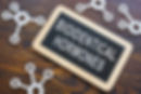 A wooden sign with the words “Bioidentical Hormones” surrounded by molecular models.