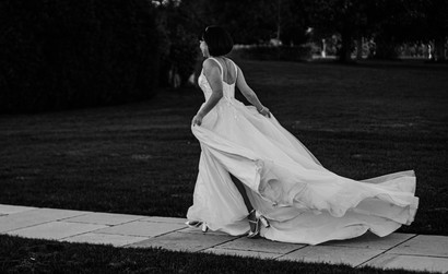 Bride running through grounds in black and white at Ivy Lodge