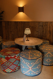 Seating are in Ivy Lodge - warm and inviting cosy corner for those wishing to escape the wedding hustle and bustle with soft lighting and fabric stools